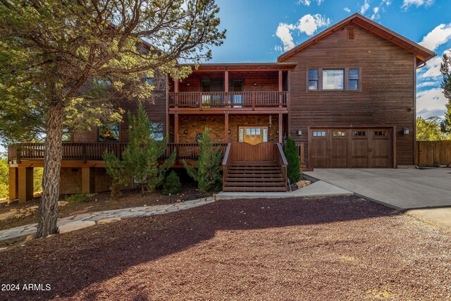 2946 N Lodgepole Rd, Overgaard, AZ 85933 - chalet / cabin with a garage, driveway, and a balcony