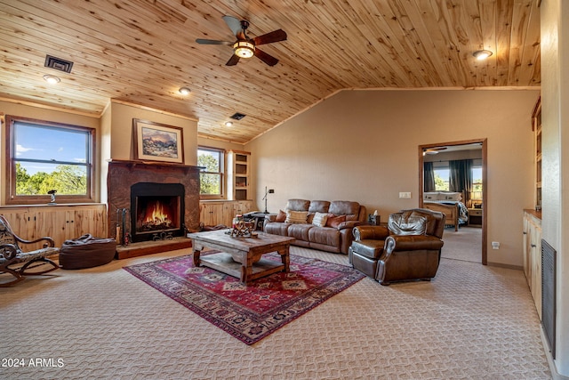 living room featuring a fireplace, a healthy amount of sunlight, and light colored carpet