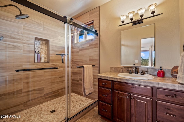 bathroom with vanity, tile patterned flooring, and a shower with door