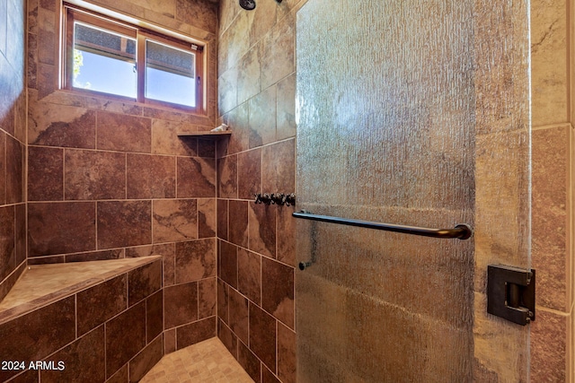 bathroom with tiled shower