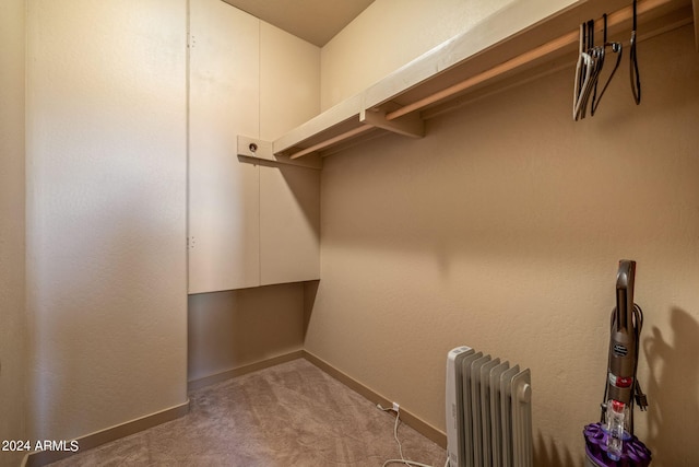 walk in closet featuring radiator heating unit