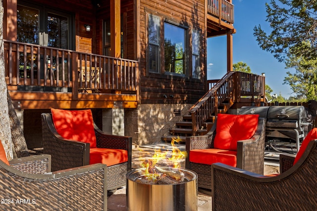 exterior space featuring an outdoor living space with a fire pit