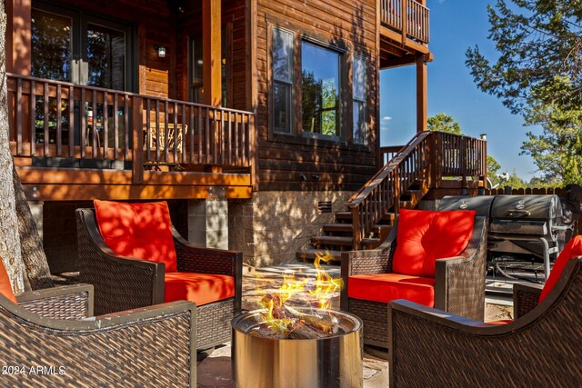 2946 N Lodgepole Rd, Overgaard, AZ 85933 - wooden terrace with stairs and an outdoor living space with a fire pit