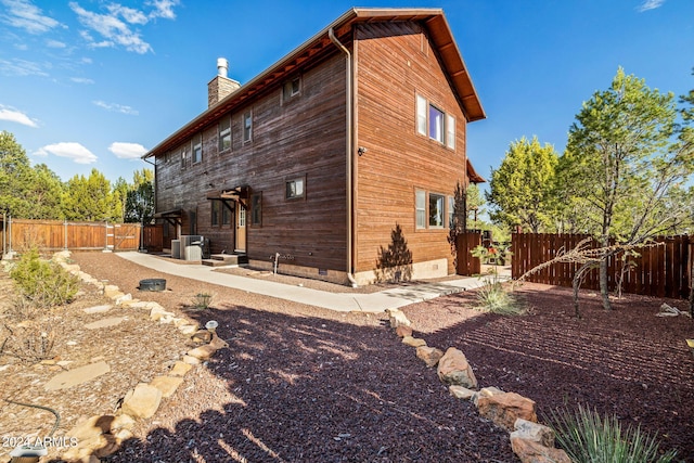 2946 N Lodgepole Rd, Overgaard, AZ 85933 - view of property exterior featuring a chimney, a fenced backyard, and cooling unit