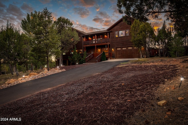 2946 N Lodgepole Rd, Overgaard, AZ 85933 - chalet / cabin featuring asphalt driveway, an attached garage, and a balcony