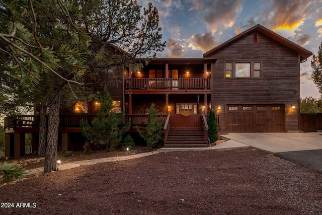 view of front of home featuring a garage and a balcony