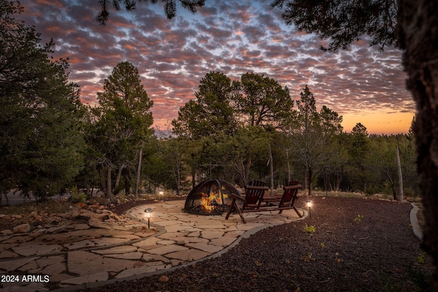 yard at dusk with a fire pit