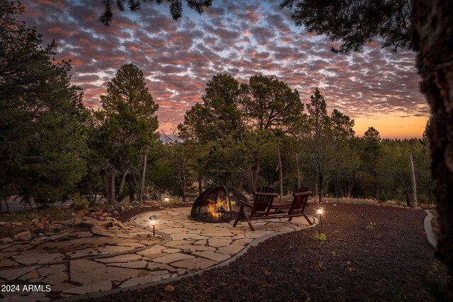2946 N Lodgepole Rd, Overgaard, AZ 85933 - yard at dusk featuring an outdoor fire pit and a patio area