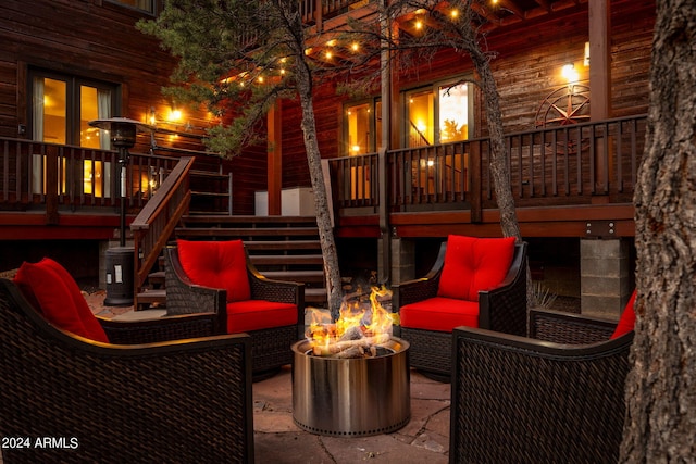 view of patio featuring an outdoor living space with a fire pit and a deck