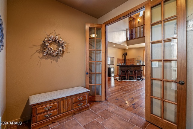 hallway with lofted ceiling and wood-type flooring