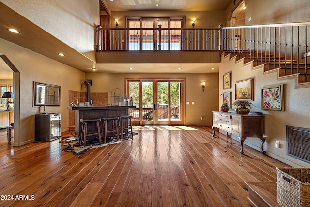 2946 N Lodgepole Rd, Overgaard, AZ 85933 - living area with a towering ceiling, hardwood / wood-style flooring, baseboards, french doors, and arched walkways