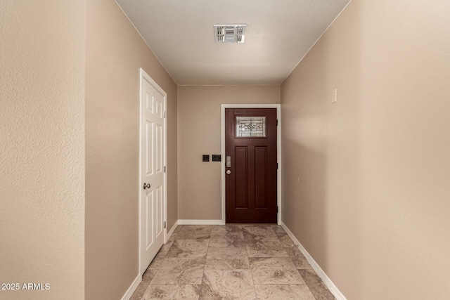 entryway with visible vents and baseboards