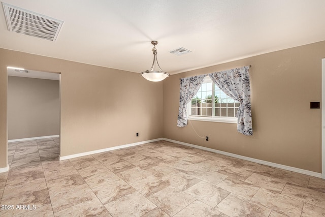 empty room with visible vents and baseboards