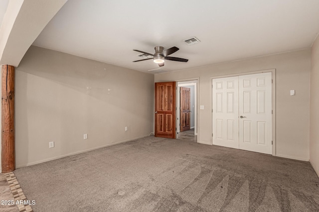 unfurnished bedroom featuring visible vents, a ceiling fan, a closet, carpet flooring, and baseboards