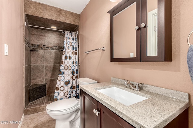 bathroom featuring a tile shower, tile patterned flooring, toilet, and vanity