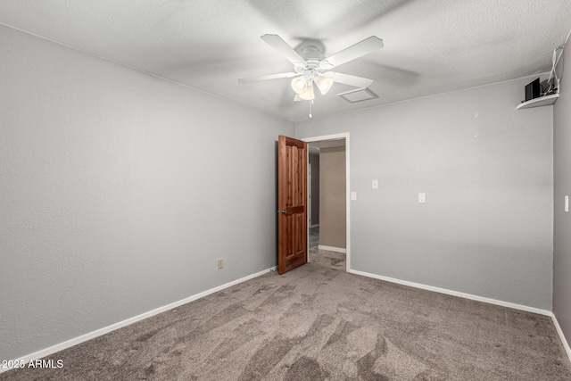 carpeted spare room featuring visible vents, baseboards, a textured ceiling, and a ceiling fan