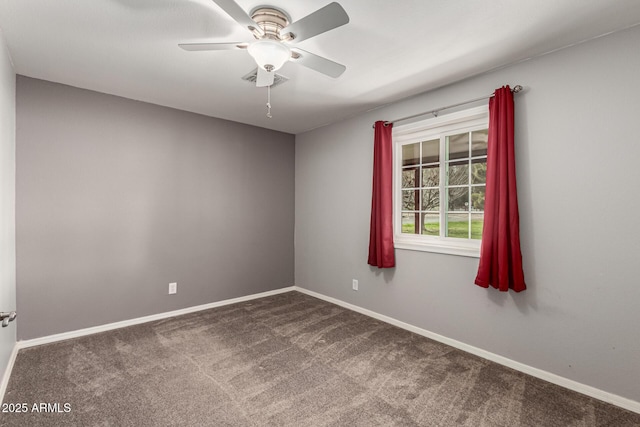 carpeted spare room with baseboards and ceiling fan