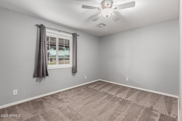 spare room featuring visible vents, baseboards, a ceiling fan, and carpet flooring