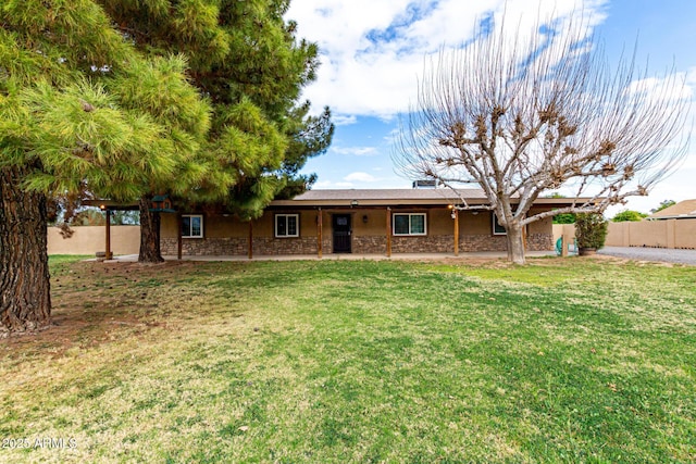 single story home featuring stone siding, a patio, a front lawn, and fence