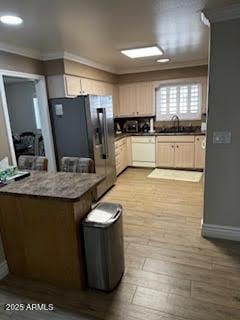 kitchen with dishwasher, sink, stainless steel fridge with ice dispenser, light hardwood / wood-style flooring, and crown molding