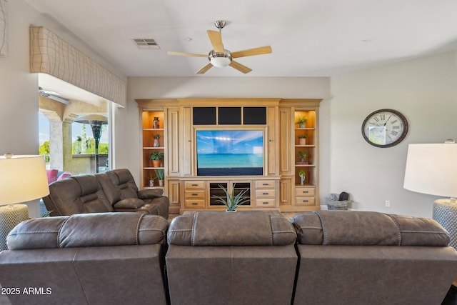 living room featuring visible vents and a ceiling fan