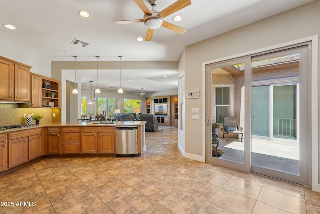 kitchen featuring visible vents, open shelves, a sink, open floor plan, and appliances with stainless steel finishes