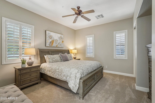 carpeted bedroom featuring ceiling fan, baseboards, and visible vents