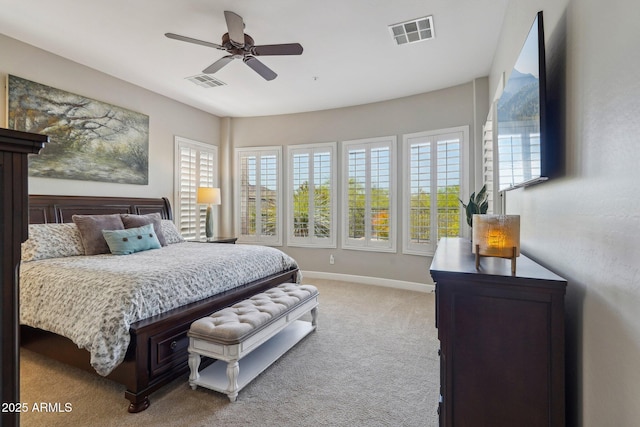 carpeted bedroom with visible vents, multiple windows, and baseboards