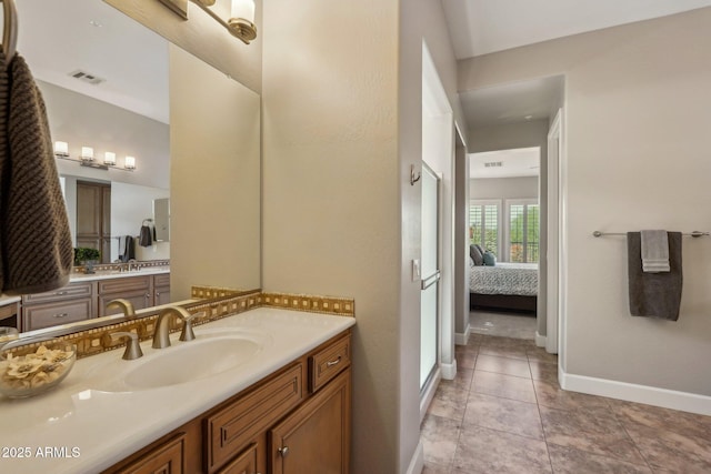 ensuite bathroom featuring vanity, ensuite bath, visible vents, tile patterned floors, and baseboards