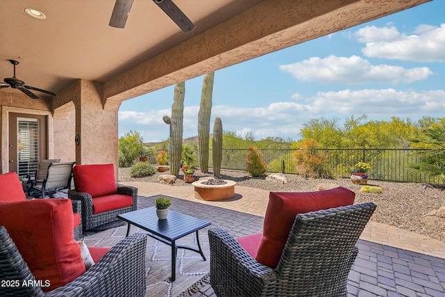 view of patio featuring an outdoor living space with a fire pit and a fenced backyard