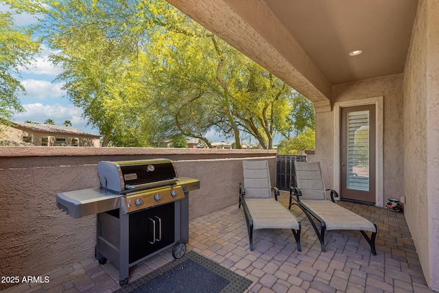 view of patio / terrace with a grill, fence, and a gate