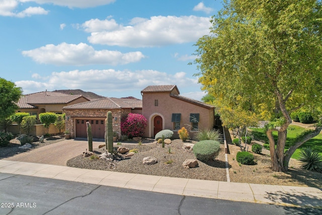 mediterranean / spanish-style house featuring a tiled roof, an attached garage, driveway, and stucco siding