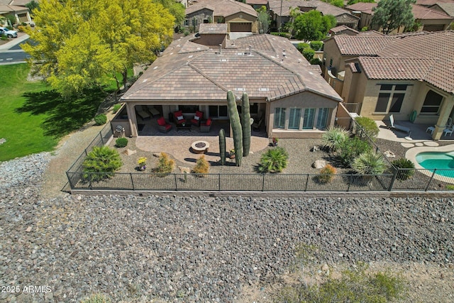 rear view of property featuring a patio area, a fenced backyard, a tile roof, stucco siding, and a residential view