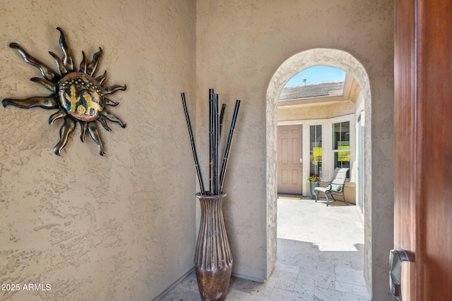 entrance to property featuring stucco siding