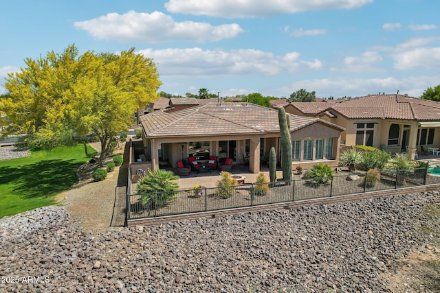 back of property featuring a patio area, stucco siding, a tiled roof, and a lawn