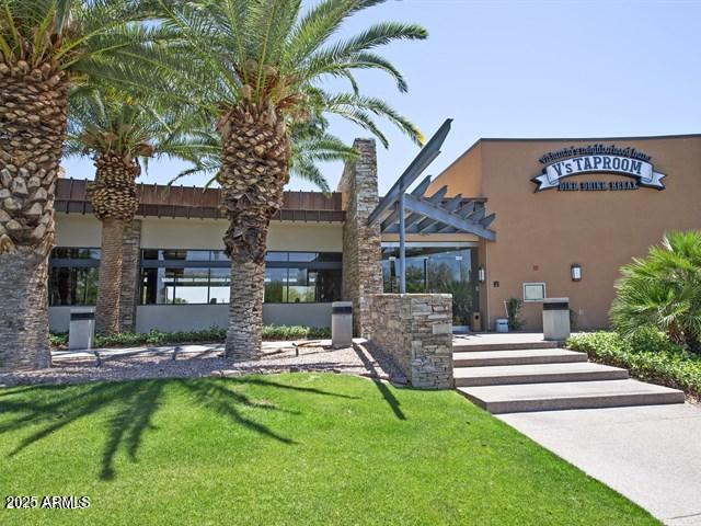 exterior space with stucco siding and a front lawn