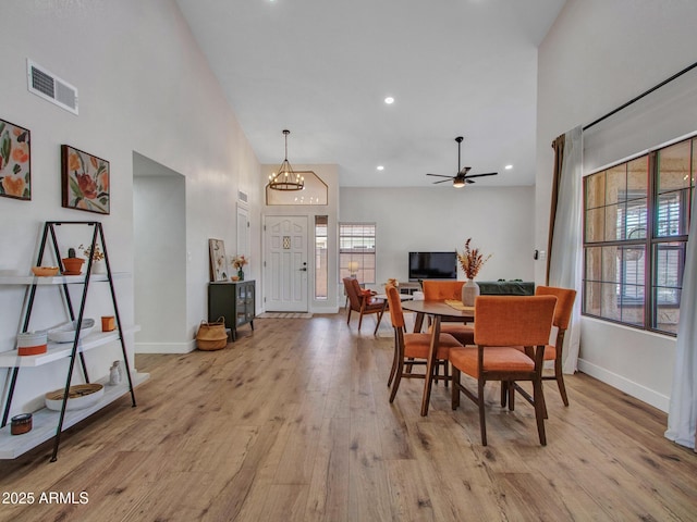 12641 S 39th Pl, Phoenix, AZ 85044 - dining space featuring light wood-style flooring, a towering ceiling, a chandelier, recessed lighting, and ceiling fan
