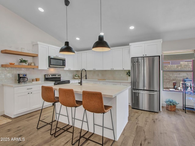 12641 S 39th Pl, Phoenix, AZ 85044 - kitchen featuring appliances with stainless steel finishes, light countertops, white cabinets, decorative backsplash, and light wood-style floors