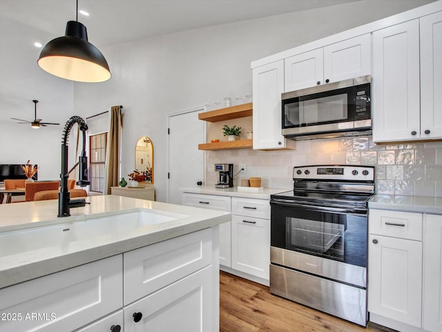 12641 S 39th Pl, Phoenix, AZ 85044 - kitchen featuring stainless steel appliances, tasteful backsplash, open shelves, and white cabinets