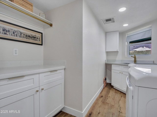 12641 S 39th Pl, Phoenix, AZ 85044 - laundry room with cabinet space, light wood-style floors, recessed lighting, and washing machine and dryer