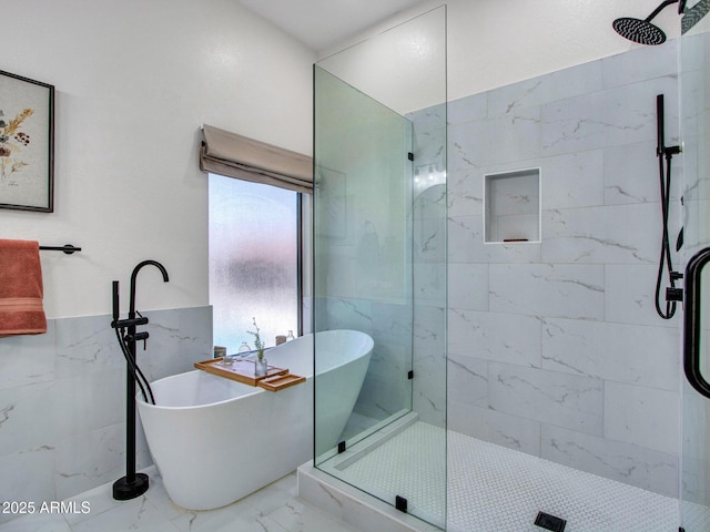 12641 S 39th Pl, Phoenix, AZ 85044 - bathroom featuring marble finish floors, tiled shower, a soaking tub, tile walls, and wainscoting