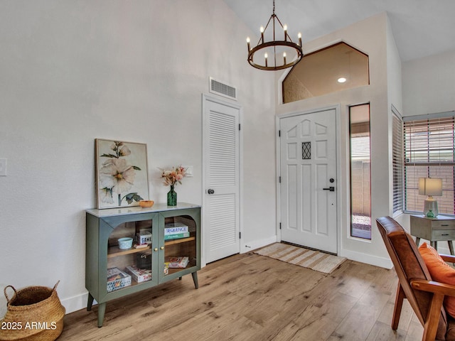 12641 S 39th Pl, Phoenix, AZ 85044 - entryway with wood finished floors, a chandelier, and high vaulted ceiling