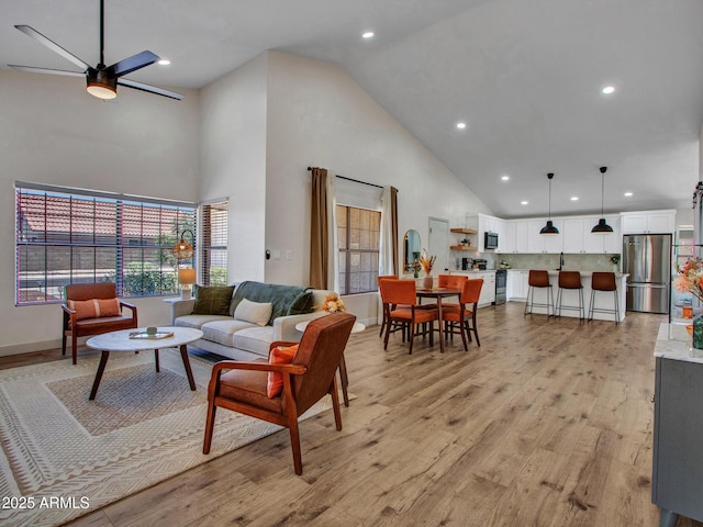 12641 S 39th Pl, Phoenix, AZ 85044 - living room featuring high vaulted ceiling, a ceiling fan, recessed lighting, light wood-style flooring, and healthy amount of natural light