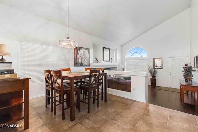 dining space with a notable chandelier and high vaulted ceiling