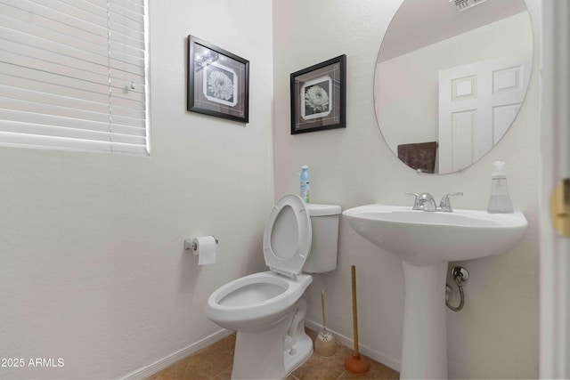 bathroom with tile patterned flooring, visible vents, toilet, and baseboards