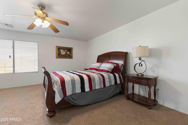 bedroom with visible vents, a ceiling fan, and carpet flooring