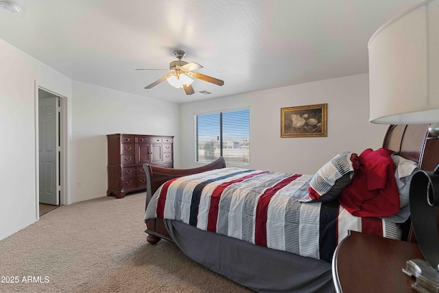 bedroom with a ceiling fan and carpet