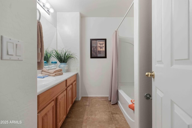 full bath featuring vanity, baseboards, shower / bath combo, and tile patterned flooring