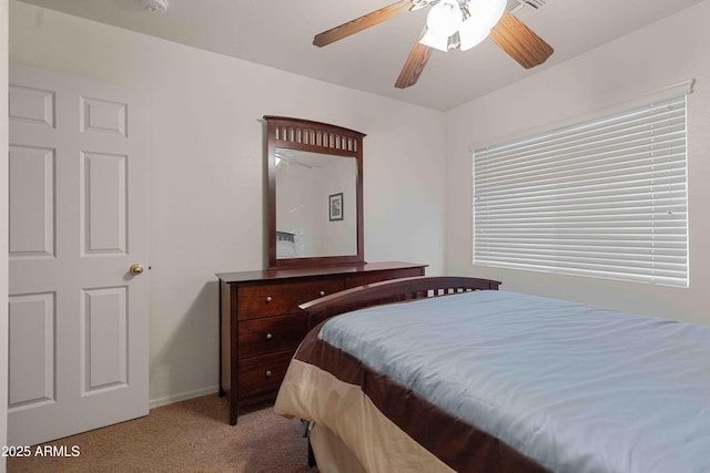 bedroom with a ceiling fan, light colored carpet, and baseboards