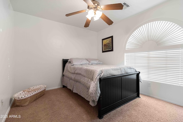 carpeted bedroom featuring ceiling fan and baseboards